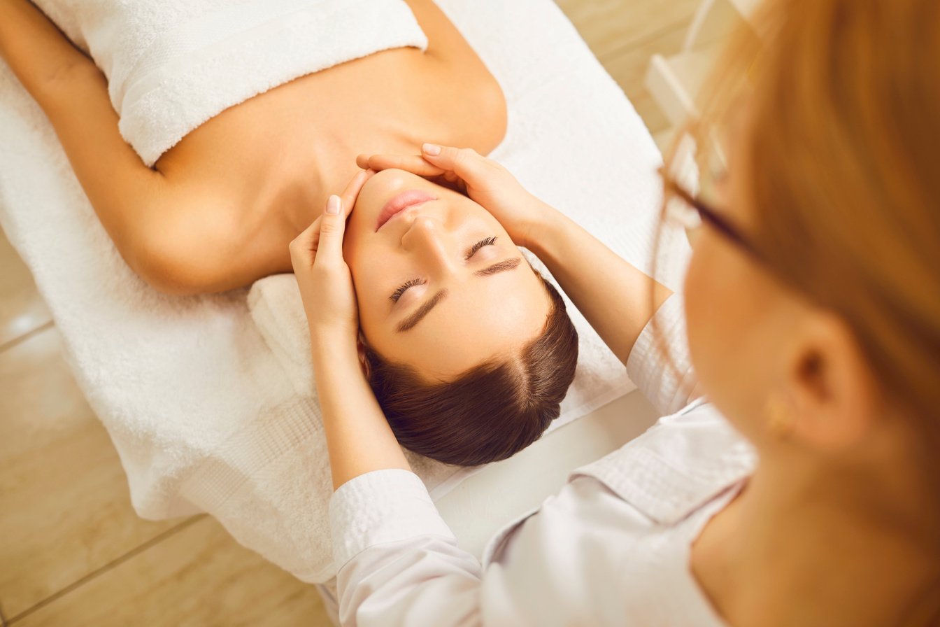 Face Massage to Young Woman Close up.